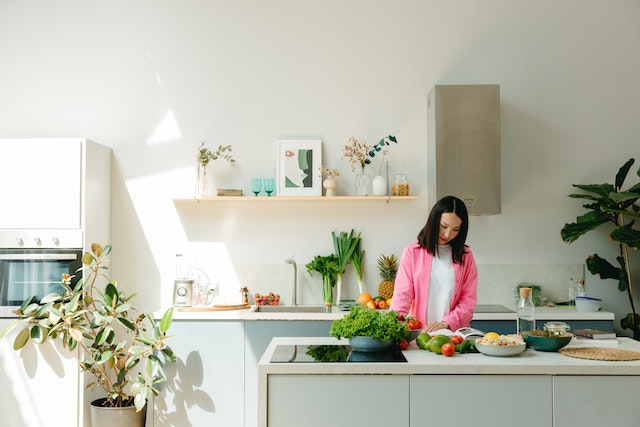 Person in a large white kitchen